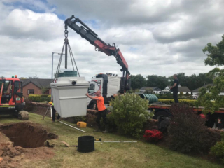 A septic tank on a crane