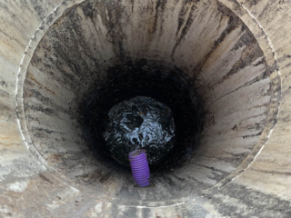 A view down a septic tank that is being emptied by Septic Tank Services Ltd