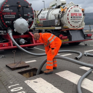 A septic tank being emptied on a main road by Septic Tank Services Ltd