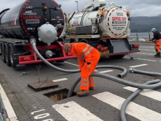 A septic tank being emptied on a main road by Septic Tank Services Ltd