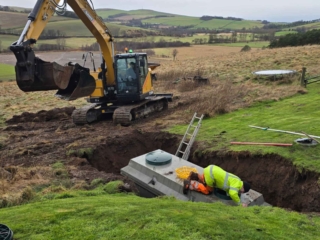 A septic tank being installed in the ground during a septic tank installation by Septic Tank Services Ltd