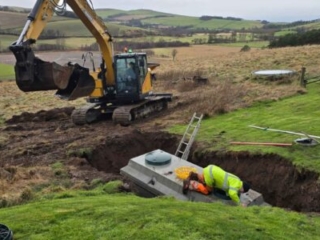 A septic tank being installed in the ground during a septic tank installation by Septic Tank Services Ltd