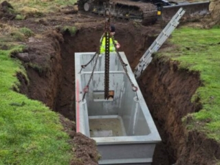 A septic tank being lowered in to the ground during a septic tank installation by Septic Tank Services Ltd