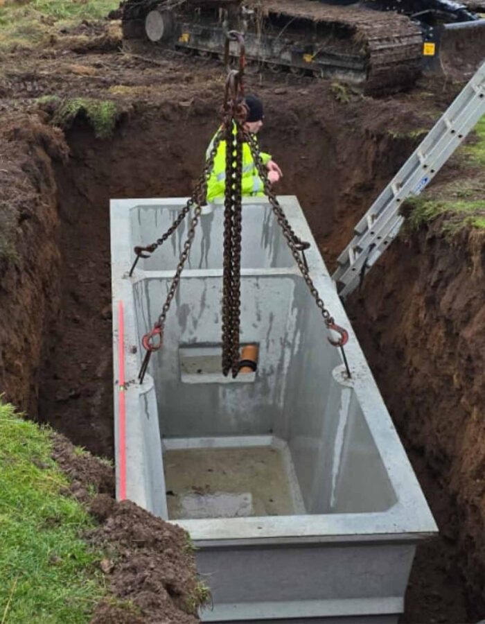 A septic tank being lowered in to the ground during a septic tank installation by Septic Tank Services Ltd