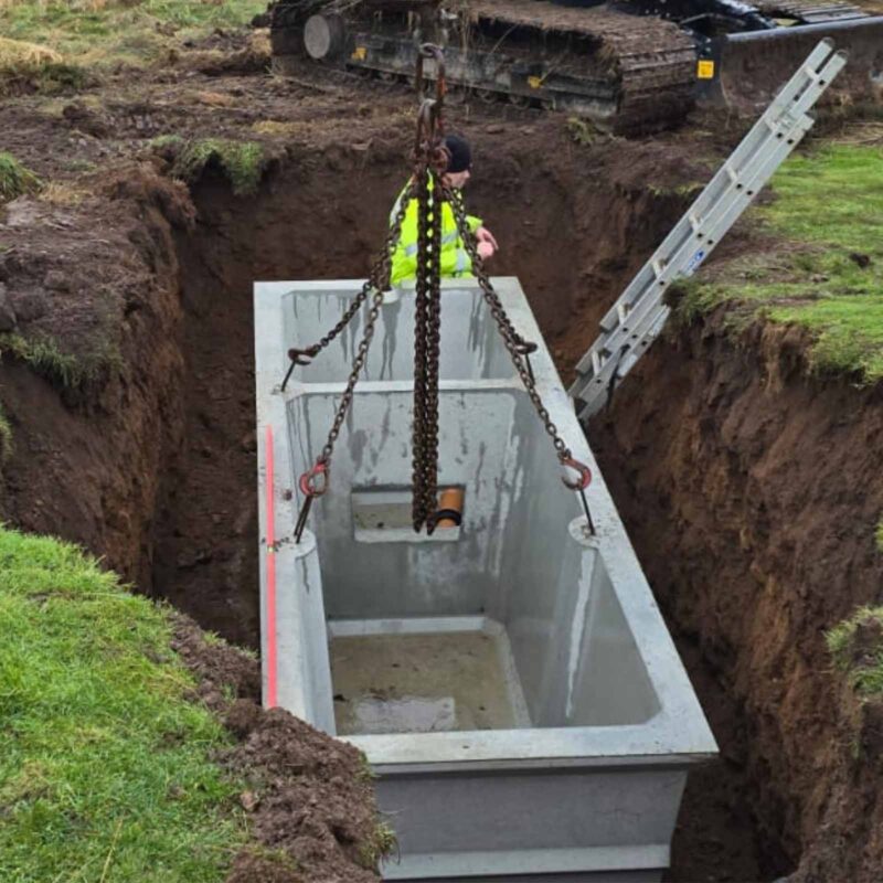 A septic tank being lowered in to the ground during a septic tank installation by Septic Tank Services Ltd