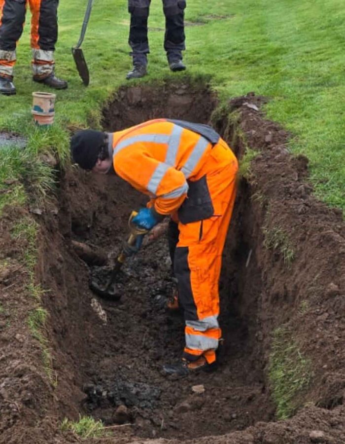 A broken septic tank pipe in the ground being worked on by Septic Tank Services Ltd
