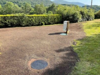 The man holes and power box with completed landscaping after a septic tank installation by Septic Tank Services Ltd