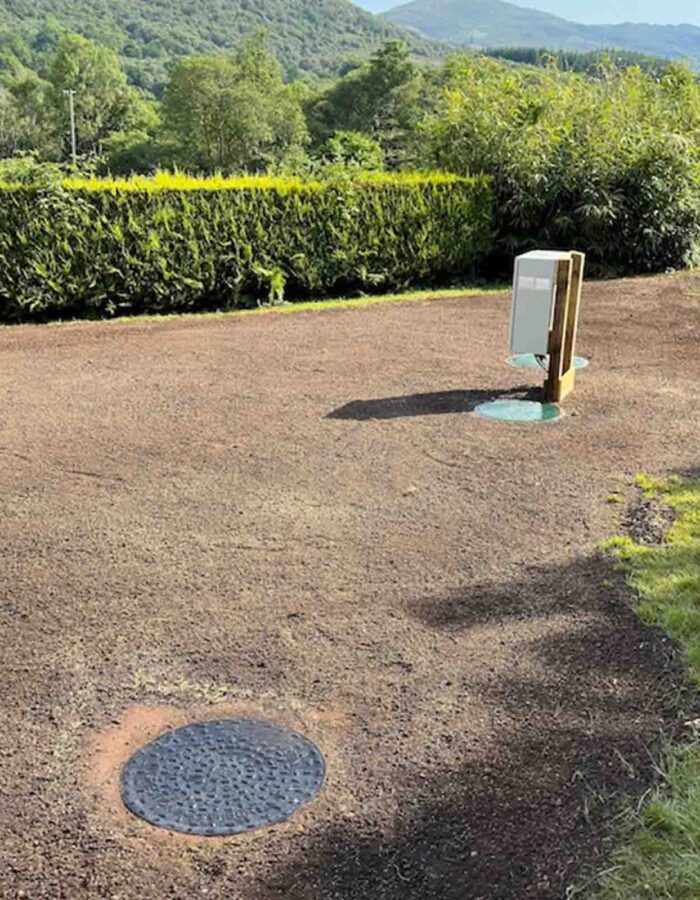 The man holes and power box with completed landscaping after a septic tank installation by Septic Tank Services Ltd