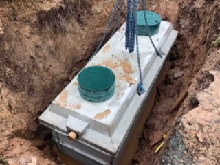 A septic tank being lowered in to the ground during a septic tank installation by Septic Tank Services Ltd