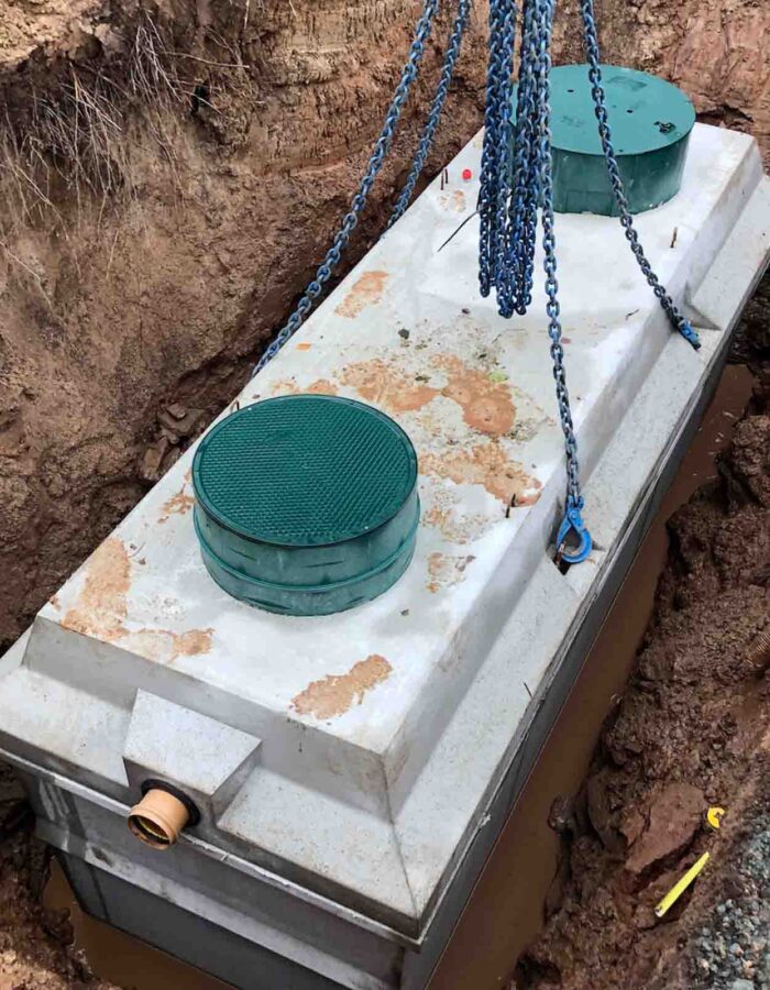 A septic tank being lowered in to the ground during a septic tank installation by Septic Tank Services Ltd