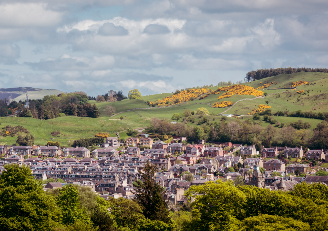 Borders town with hills and blue sky.